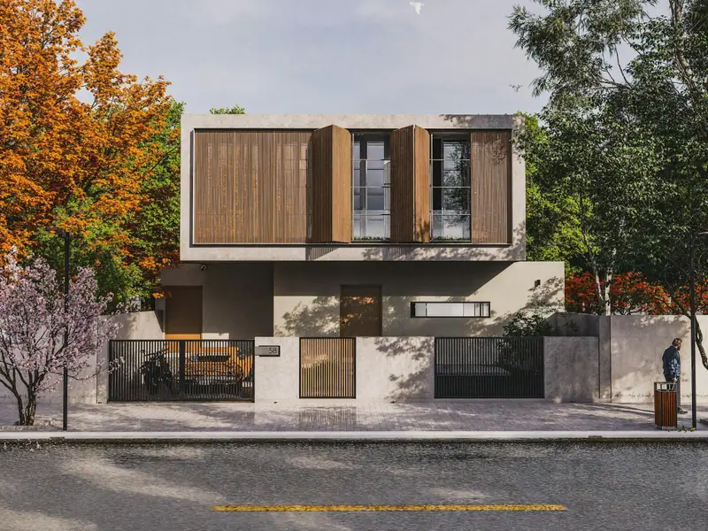 Façade de béton et de bois derrière des arbres d’automne